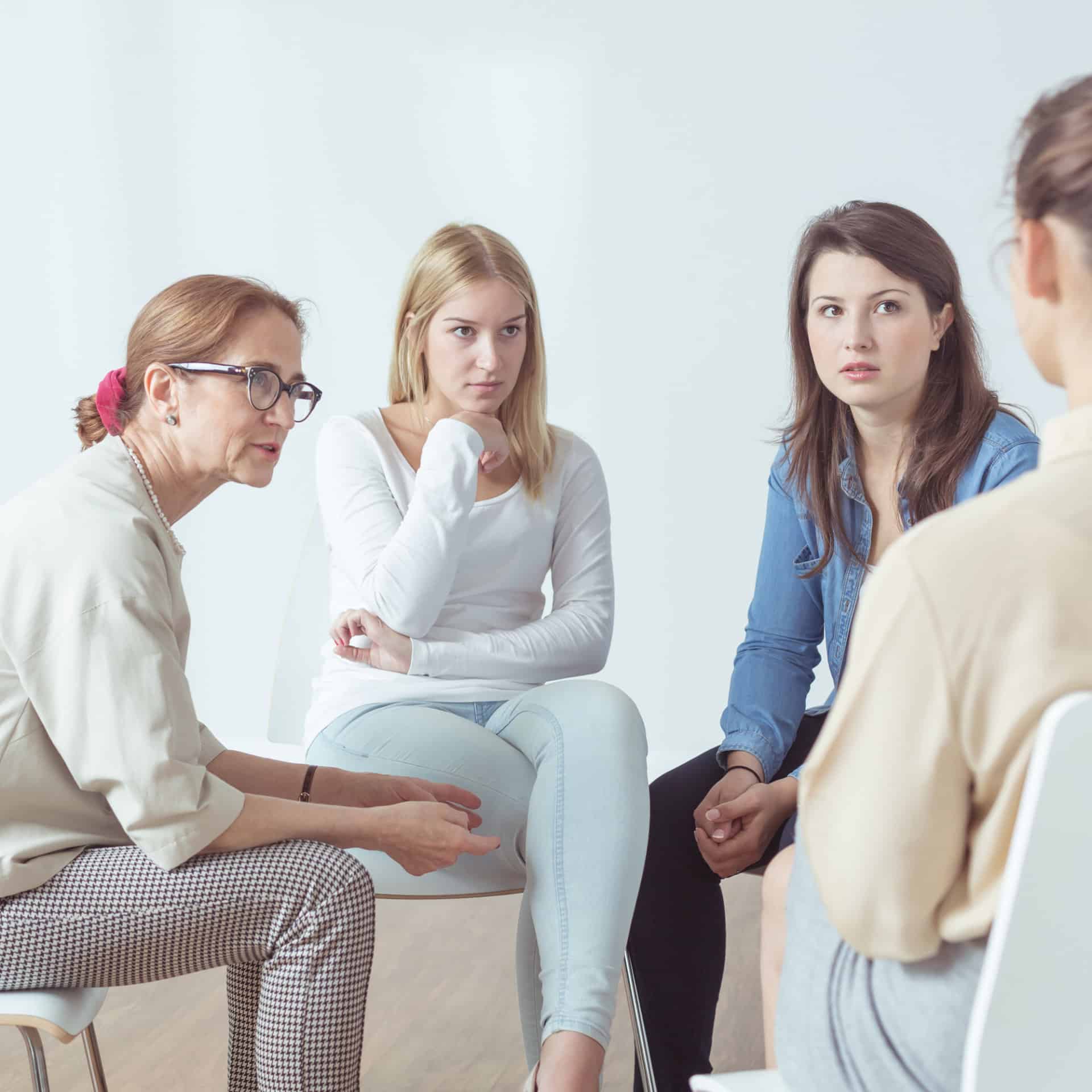 Counseling group gathering in circle talking